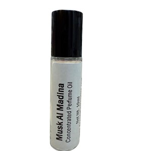 May include: A roll-on bottle of Musk Al Madina Concentrated Perfume Oil. The bottle has a black cap and a white label with the product name and net weight of 10ml.
