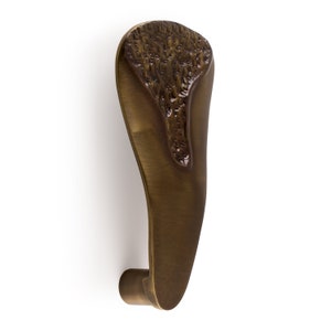 May include: A bronze door handle with a textured, organic design. The handle is shaped like a teardrop and has a smooth, polished finish.