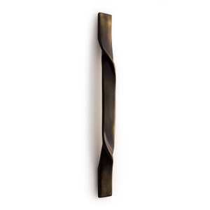 May include: A twisted, antique brass cabinet pull with a smooth, brushed finish.