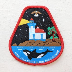 May include: A red, white, and blue embroidered patch with a lighthouse, a flying bird, a whale, and the text "Lime Kiln Point + San Juan Island".