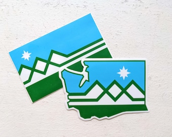 May include: Two stickers featuring a blue, white, and green design. One sticker is rectangular, and the other is shaped like a state. Both have a star and mountain graphic.