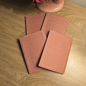 May include: Four vintage books with dusty rose covers, each featuring embossed text on the front. The titles include An Evening with Lincoln, An Evening with Longfellow, An Evening with Scott, and An Evening with Thackeray, all published by Sherwin Cody.