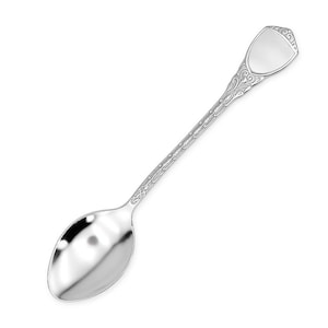 May include: A silver spoon with an ornate handle and a shield-shaped top. The spoon's bowl is oval, and the handle features detailed floral patterns. The spoon is made of a shiny, reflective metal.
