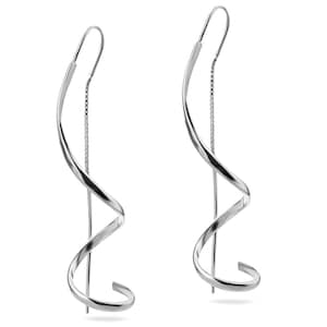 May include: A pair of silver spiral earrings with a delicate chain hanging from the bottom of each earring.