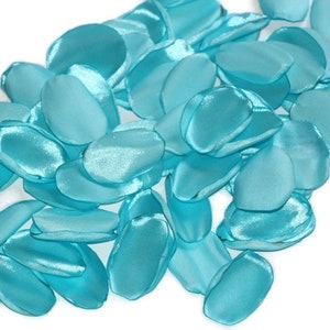 May include: A pile of teal blue satin rose petals. The petals are soft and silky, and they would be perfect for a wedding or other special event.