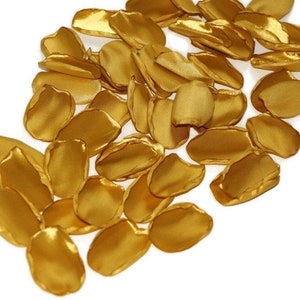 May include: A pile of gold satin rose petals, perfect for wedding decorations or special events.