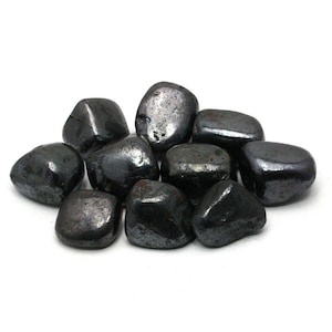 May include: A collection of ten smooth, black hematite tumbled stones. The stones are various sizes and shapes, with a slightly iridescent sheen.