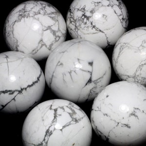 May include: Seven white and gray marbled spheres, each with a unique pattern of veins and swirls.