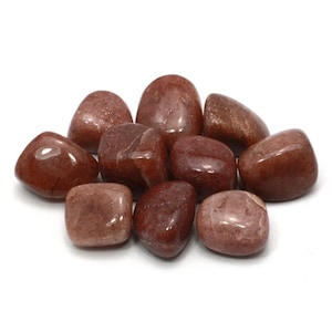 May include: A collection of ten tumbled red jasper stones. The stones are smooth and polished, with a variety of shades of red and brown.