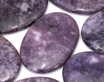 May include: A collection of eight smooth, oval-shaped purple lepidolite stones. The stones have a natural, polished finish and a variety of purple hues.