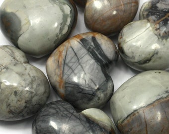 May include: A collection of seven heart-shaped polished stones with a variety of brown, grey, and black patterns.
