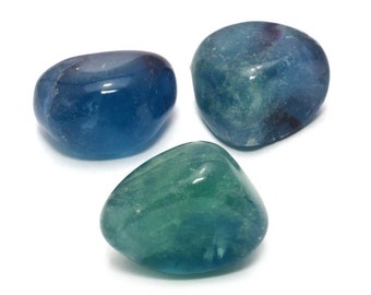 May include: Three tumbled fluorite stones in shades of blue and green. The stones are smooth and polished, with a natural, organic shape.