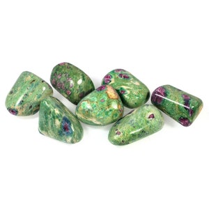 May include: Six green and pink tumbled stones with a speckled pattern.