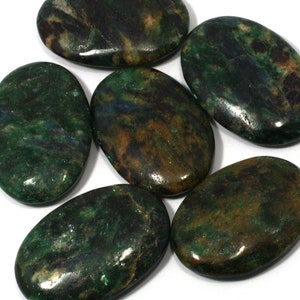 May include: Six polished oval stones with a mix of green, brown, and blue hues. The stones have a smooth, glossy surface, and the colors blend together in a natural, organic pattern. These stones are likely used for decorative or metaphysical purposes.
