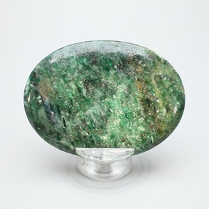 May include: A green and brown oval shaped cabochon gemstone with a sparkly finish.