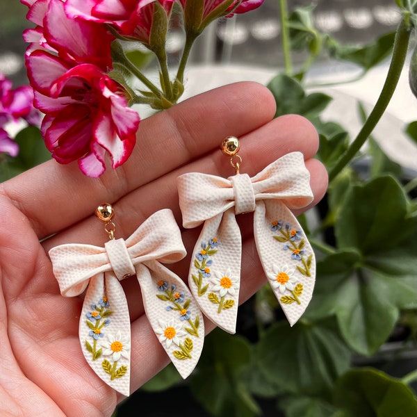 Floral bow polymer clay dangle earrings with wildflower and daisy
