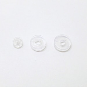 May include: Three clear plastic rings of different sizes. The rings are all round and have a hole in the centre.
