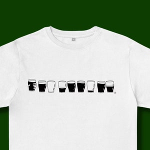 May include: White t-shirt with a black graphic of a row of pint glasses, some full and some empty.