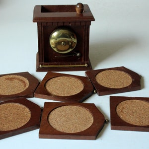 6 wooden coasters in a decorative wooden box with a bell, vintage from the 1950s, mid century, 6 wooden coasters in a wooden box