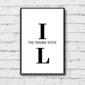 Puede incluir: Impresión en blanco y negro con las letras "IL" y el texto "THE PRAIRIE STATE" en un estilo minimalista.