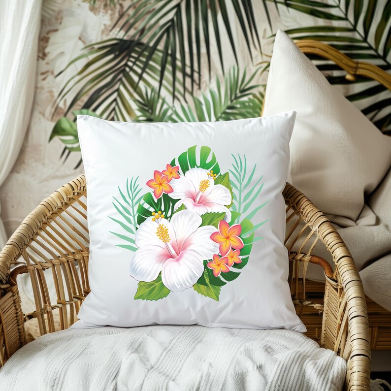 Puede incluir: Almohada blanca con un dise&ntilde;o floral con flores de hibisco rosas y blancas y hojas verdes.
