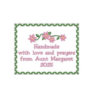 以下が含まれることがあります： 白い背景に緑色の枠線とピンクの花が描かれたデザイン。テキストは「Handmade with love and prayers from Aunt Margaret 2025」です。