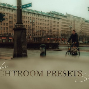 May include: A person rides a bicycle down a city street in front of a large building. The image is faded and has a vintage look. The text "mobile LIGHTROOM PRESETS streets" is at the bottom of the image.