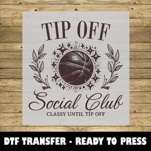 May include: A basketball-themed design with the words "TIP OFF" at the top and "Social Club" below, with a basketball graphic in the center. The phrase "CLASSY UNTIL TIP OFF" is also included. The words "DTF TRANSFER - READY TO PRESS" are at the bottom.