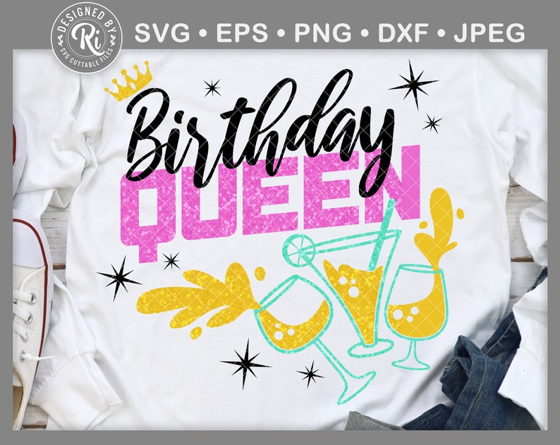 May include: A white t-shirt with the text "Birthday Queen" in pink glitter lettering. The design also includes a crown, stars, and a yellow and turquoise illustration of a cocktail glass.