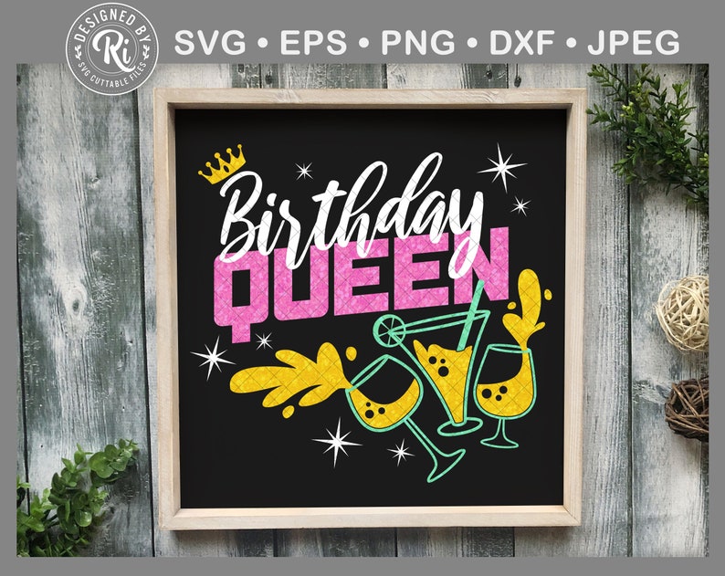 May include: A black chalkboard sign with a white background and the text "Birthday Queen" in pink and yellow letters. There are gold stars and a crown above the text and a yellow and green illustration of a cocktail drink below the text.