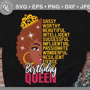 May include: A black t-shirt featuring a graphic design of a woman with an afro wearing a crown. The text "Birthday Queen" is written in pink letters below the woman's face. The text "Sassy, Worthy, Beautiful, Intelligent, Successful, Influential, Passionate, Wonderful, Resilient, Fierce" is written in yellow letters to the right of the woman's face.