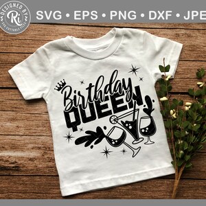 May include: White t-shirt with black text that says "Birthday Queen" with a crown above the word "Birthday" and a design of three martini glasses with a lime and a straw.