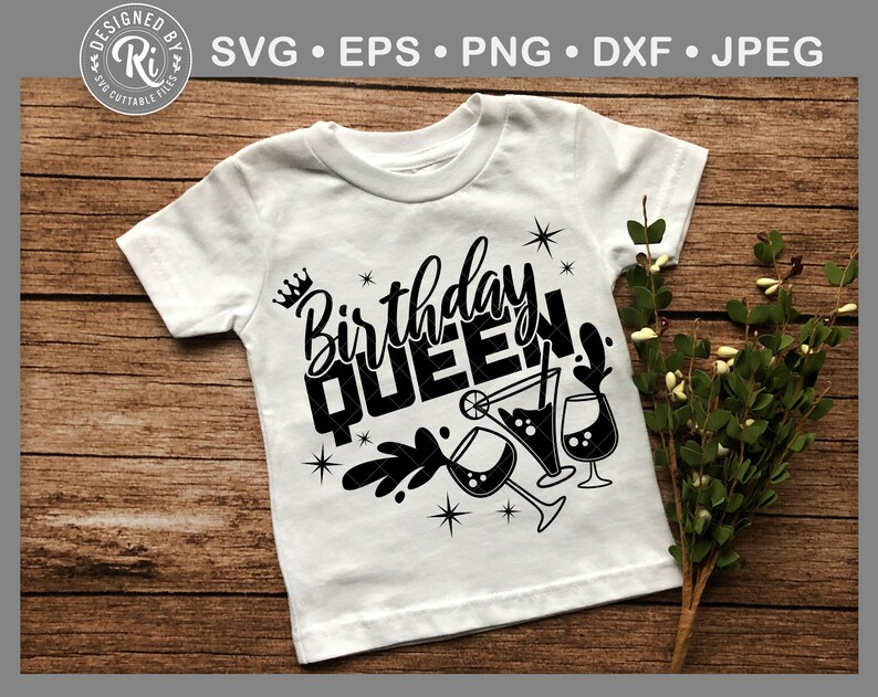 May include: White t-shirt with black text that says "Birthday Queen" with a crown above the word "Birthday" and a design of three martini glasses with a lime and a straw.