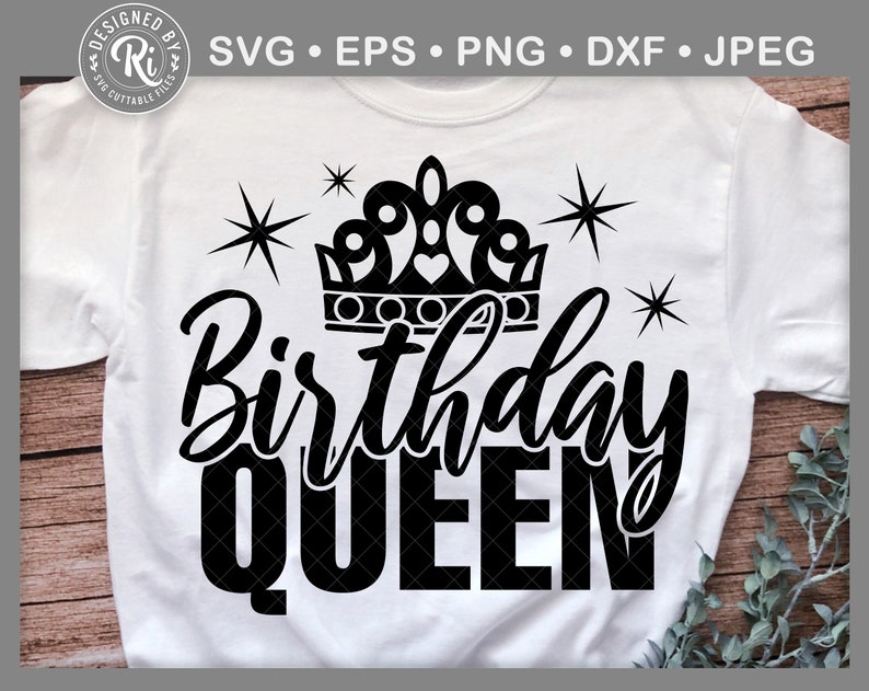 May include: White t-shirt with a black graphic. The design includes a crown, starbursts, and the words "Birthday QUEEN" in a bold font. The t-shirt has a crew neck.