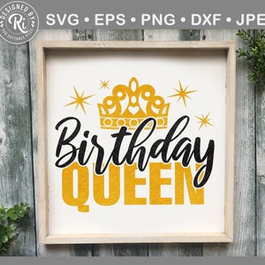 May include: A framed sign with the words "Birthday QUEEN" in black and gold lettering. A gold crown and starbursts are above the text. The sign is in a light wood frame.