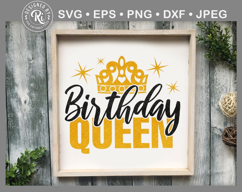 May include: A framed sign with the words "Birthday QUEEN" in black and gold lettering. A gold crown and starbursts are above the text. The sign is in a light wood frame.