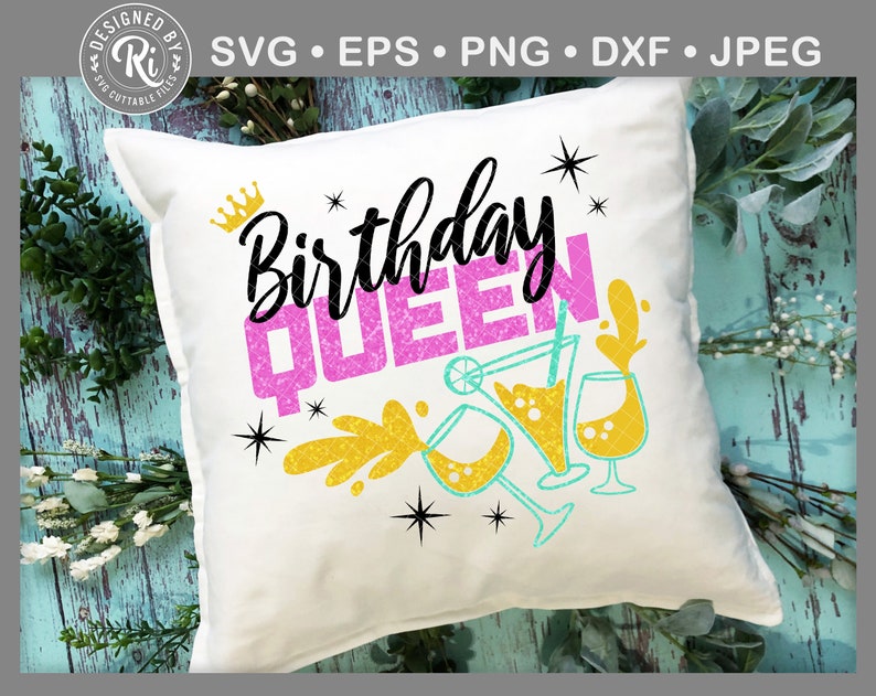 May include: White pillow with the text "Birthday Queen" in pink glitter lettering. The text is surrounded by gold glitter and blue and green cocktail glasses.