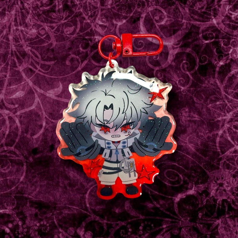 May include: A clear acrylic charm featuring a stylized anime character with white hair, red star-shaped eyes, and black gloves. The charm has a red lobster clasp and a red star accent. The character is set against a red and orange background.