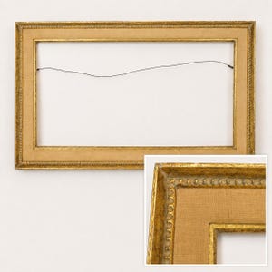 May include: A rectangular picture frame with a distressed gold finish and a wide, textured tan linen liner. The frame features a beaded inner edge detail and a thin black wire attached to the back for hanging purposes. A close-up view shows the texture.