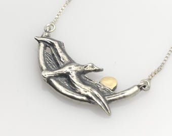 Albatross silver pendant with solid gold sun