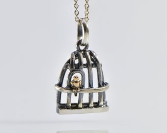 Gold bird escaping from cage ,silver charm with 9k solid gold bird