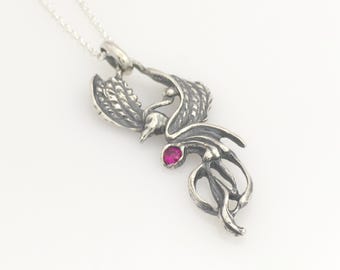 Silver phoenix pendant with lab grown ruby gem