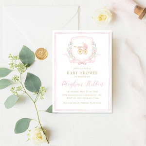 May include: Pink and gold baby shower invitation with a watercolor illustration of a carriage and a floral wreath. The invitation reads "Join us for a Baby Shower in honor of Meghan Hilton" and includes the date, time, address, RSVP information, and registry details.