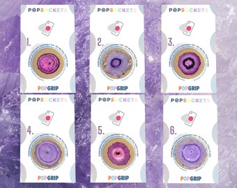 May include: Six different phone grips with a purple and pink agate design. Each grip has the text "POPGRIP" and "POPSOCKETS" printed on it. The grips are numbered 1 through 6.