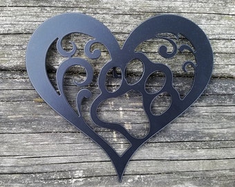 May include: Black metal heart-shaped wall decor with a paw print design and intricate scrollwork.