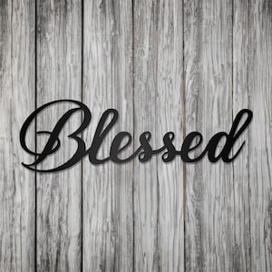 May include: Black metal wall decor with the word "Blessed" in a cursive font.
