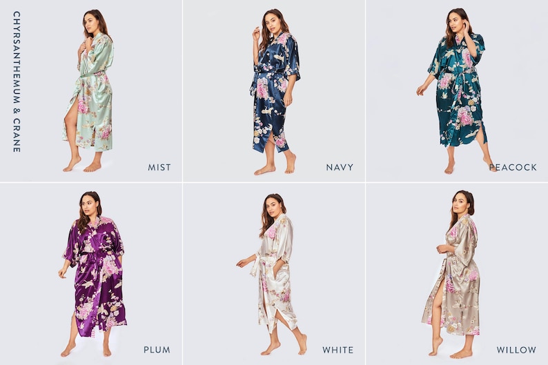 May include: A collection of six satin robes featuring the Chrysanthemum & Crane print in various colors including mist, navy, peacock, plum, white, and willow. Each robe has a tie waist, three-quarter length sleeves, and a floral pattern.