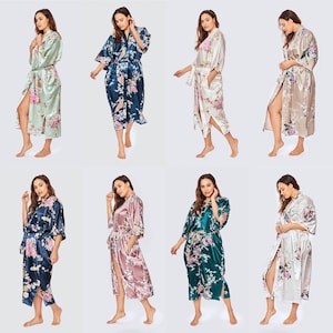 May include: Ten women's robes in different colors and floral patterns. The robes are made of satin and have long sleeves and a tie belt.