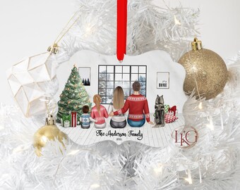 May include: A personalized Christmas ornament featuring a family scene with a Christmas tree, a window with a snowy view, and a dog. The ornament has the text "The Anderson Family 2021". It is hanging with a red ribbon.