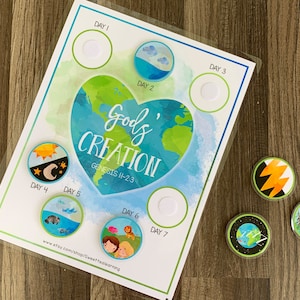 May include: A printable chart for teaching children about God's creation. The chart features a heart-shaped earth with the words "God's Creation" and "Genesis 1-2:3". There are seven circles with days of the week and blank spaces for stickers. The chart is on a wooden surface with seven colourful stickers.